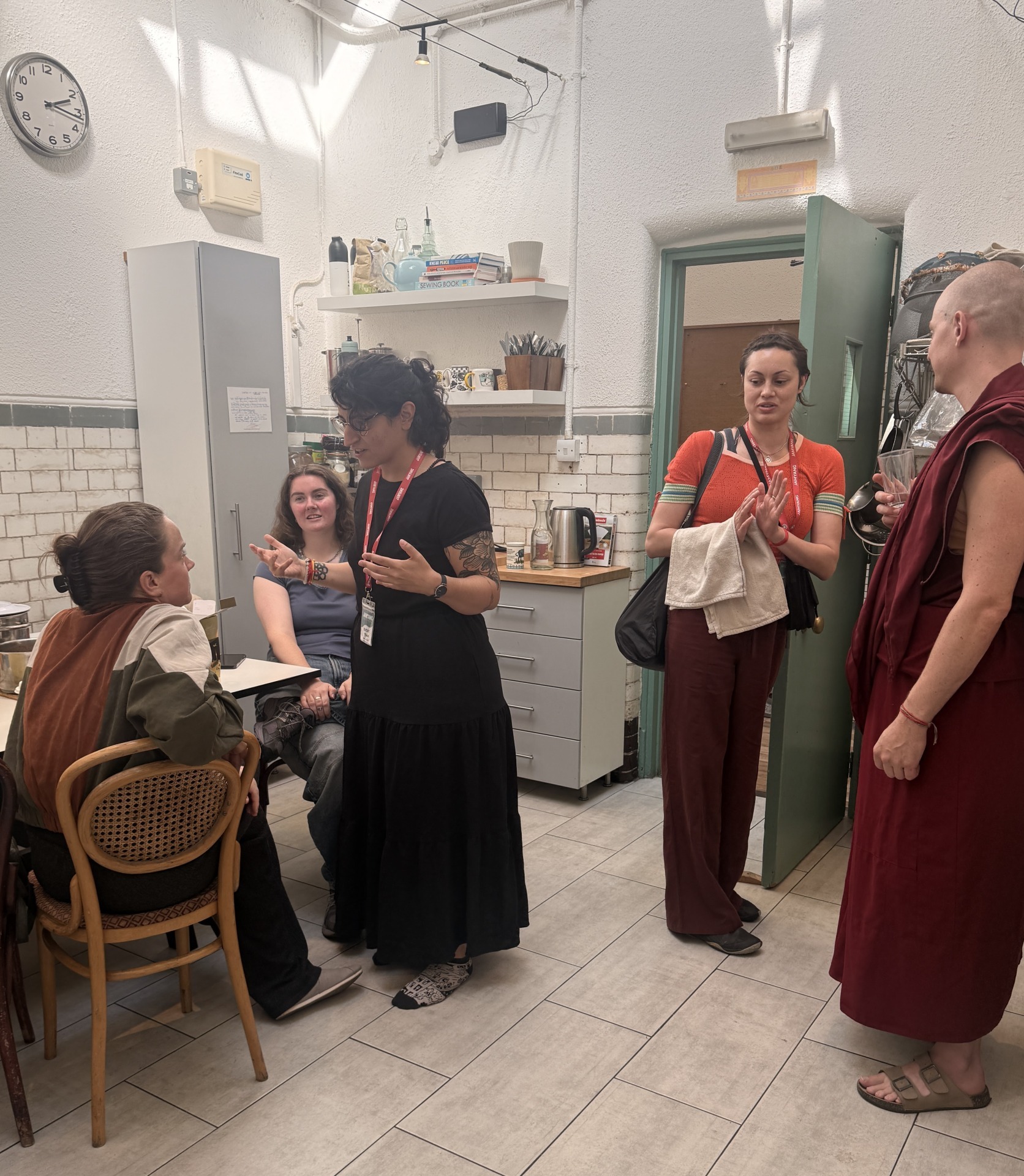 Iris, a translator, Kate on the Cafe team, Zola from hospitality and Ven Jampa on the ritual attendant team, chatting with Jasmine Photo Courtesy of JBC's newsletter