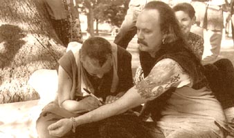 Rinpoche writes on the arm of a tattoo artist in Decatur, Illinois, August 97