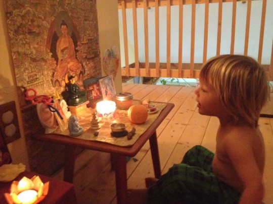 Kasia's son sitting at his altar. Photo courtesy of Kasia Beznoska.
