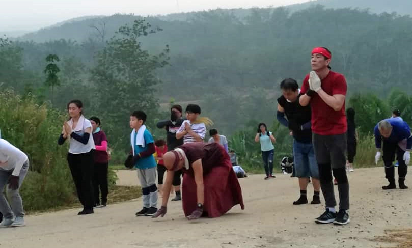 Prostrating Up a Hill at Rinchen Jangsem Ling Retreat Centre in Malaysia