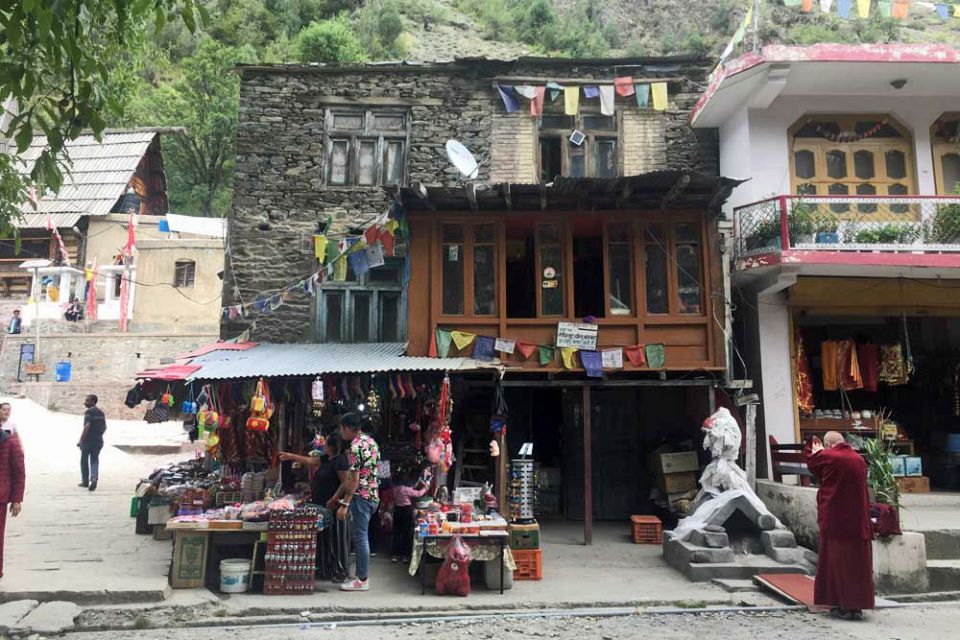 Interesting looking old buildings and a trinket shop on the ground level in a village.
