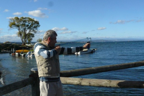 Murray Wright uses a slingshot to offer the Padmasambhava crystal to Lake Taupo, March 2013. Photo courtesty of Murray Wright.