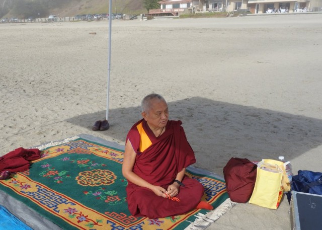 Rinpoche on the beach doing the prayers and mantras for blessing the ocean and creatures within while most of the Sangha are in the water moving the mantra boards through the waves, Califorania, October 26, 2013. Photo by Ven. Roger Kunsang. 