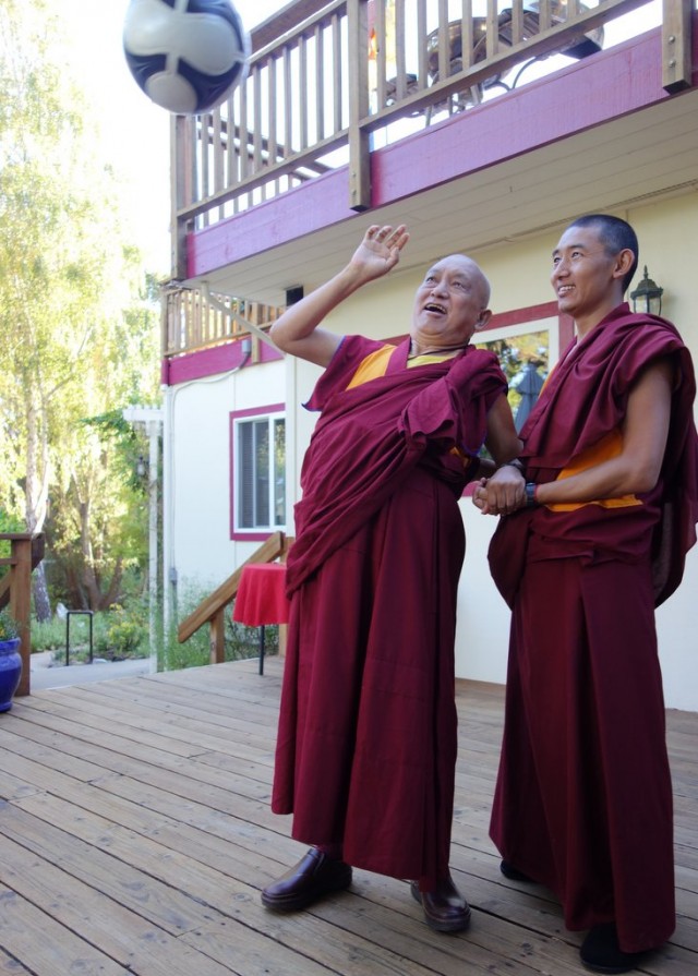 Lama Zopa Rinpoche bats down a soccer ball to improve strength and coordination