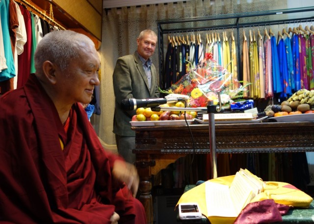 Lama Zopa Rinpoche teaching to the Nepali staff of Yak and Yeti on the good heart. Marcel Bertels in the background with some of the fine silk clothing they manufacture. December 5, 2013 Photo by Ven. Roger Kunsang.