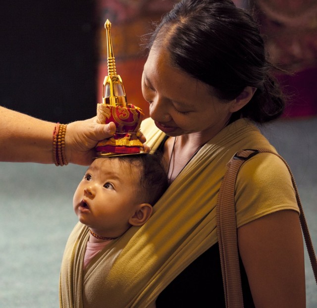 A mother and child receiving blessing from relics, Mullumbimby, Australia, 2012. Photo by Andy Melnic.