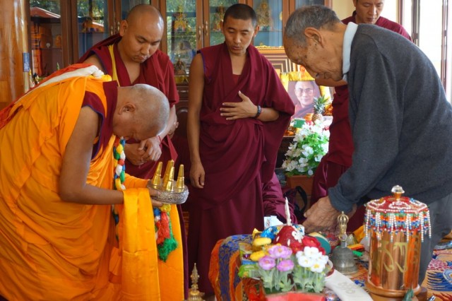 Lama Zopa Rinpoche offering a mandala to Khyongla Rato Rinpoche, Sera Monastery, India, January 2014. Photo by Ven. Roger Kunsang.