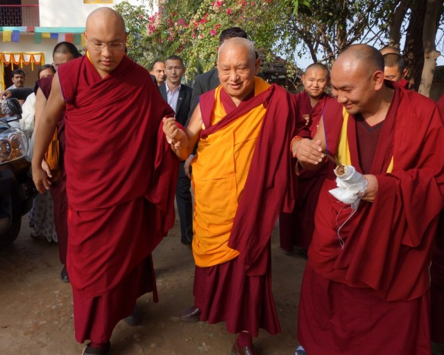 His Holiness the Karmapa and Lama Zopa Rinpoche walking from Maitreya School to Root Institute, Bodhgaya, India, January 2014. Photo by Ven. Roger Kunsang.