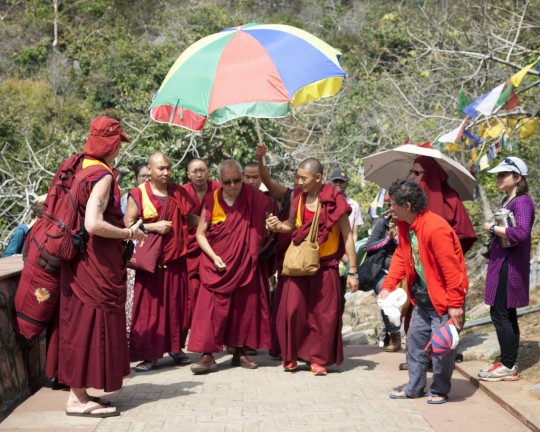 Lama Zopa Rinpoche walking up to Vulture's Peak, India, March 2014. Photo by Andy Melnic.