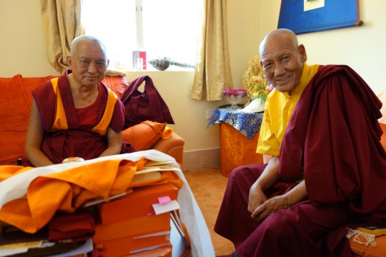 Lama Zopa Rinpoche with the attendant of the previous Khunu Lama Rinpoche, Bodhgaya, India, March 2014. Photo by Ven. Roger Kunsang.