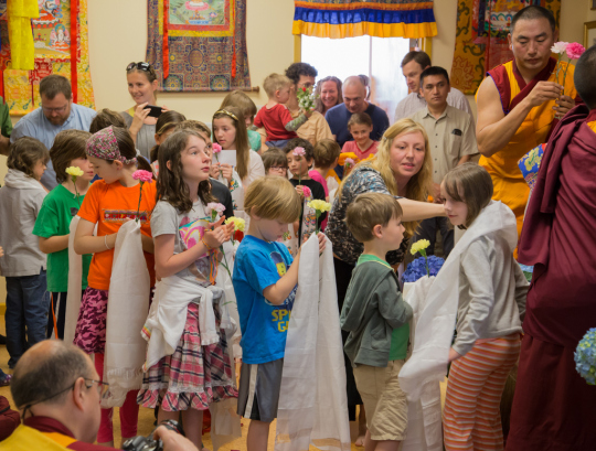 Children offering khatas to Lama Zopa Rinpoche at Kadampa Center, May 3, 2014. Photo copyright David Stravel. 