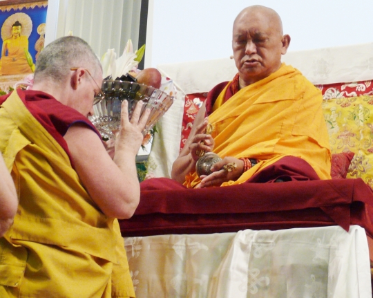 Lama Zopa Rinpoche being offered tsog by Ven. Chantal, director of International Mahayana Institute, during Light of the Path Retreat, May 2014. Photo by Kalleen Mortensen.