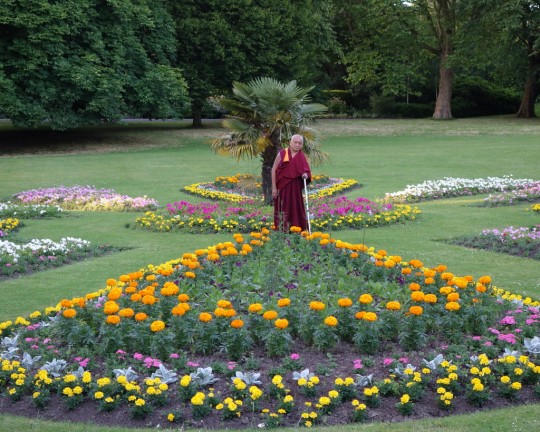 Lama Zopa Rinpche in a park in Leeds offering all the flowers to the 